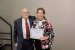 Dr. Nagib Callaos, General Chair, giving Prof. Zainab Z. Ismail the best paper award certificate of the session "Bio-Informatics and Health-Care." The title of the awarded paper is "Novel Application of Immobilized Bacillus Cells for Biotreatment of Furfural-Laden Wastewater."